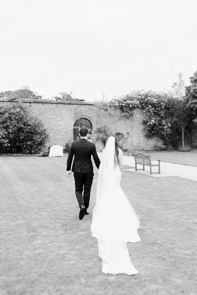 Bride and groom leaving the formal garden 