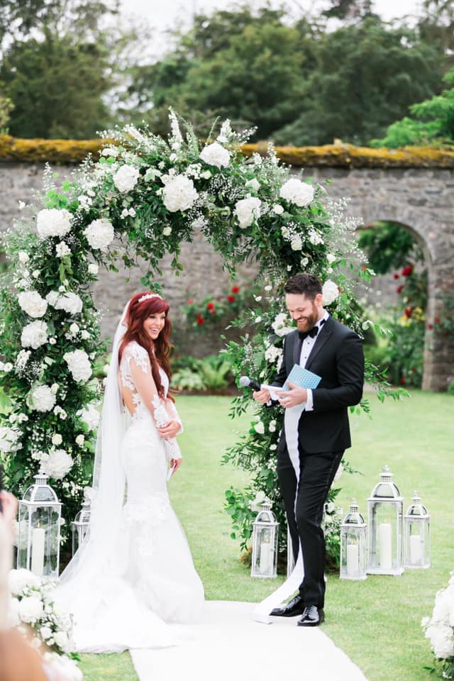 Bride and Groom laughing when the groom reads his vows