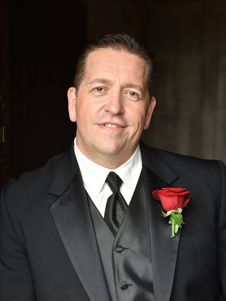 Father of the bride wearing a rose boutonniere