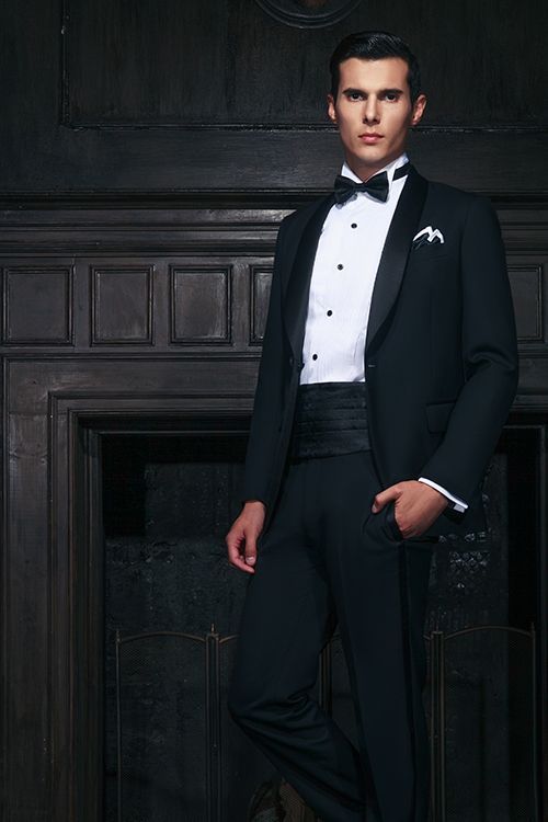 Man wearing a tuxedo with a cummerbund.