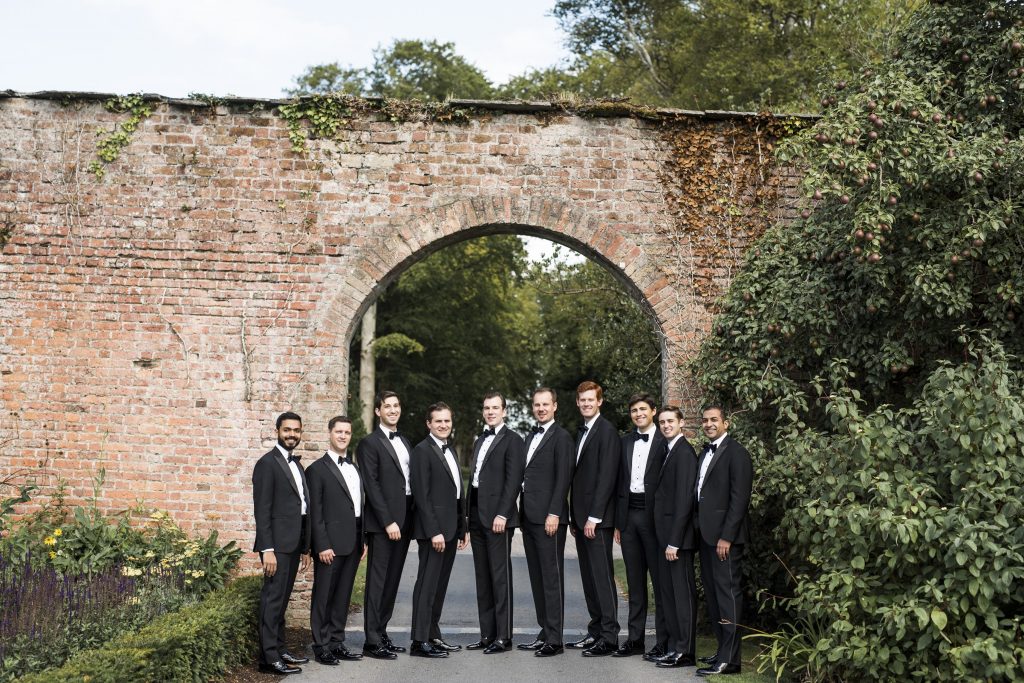 Groom and his groomsmen wearing tuxedos.