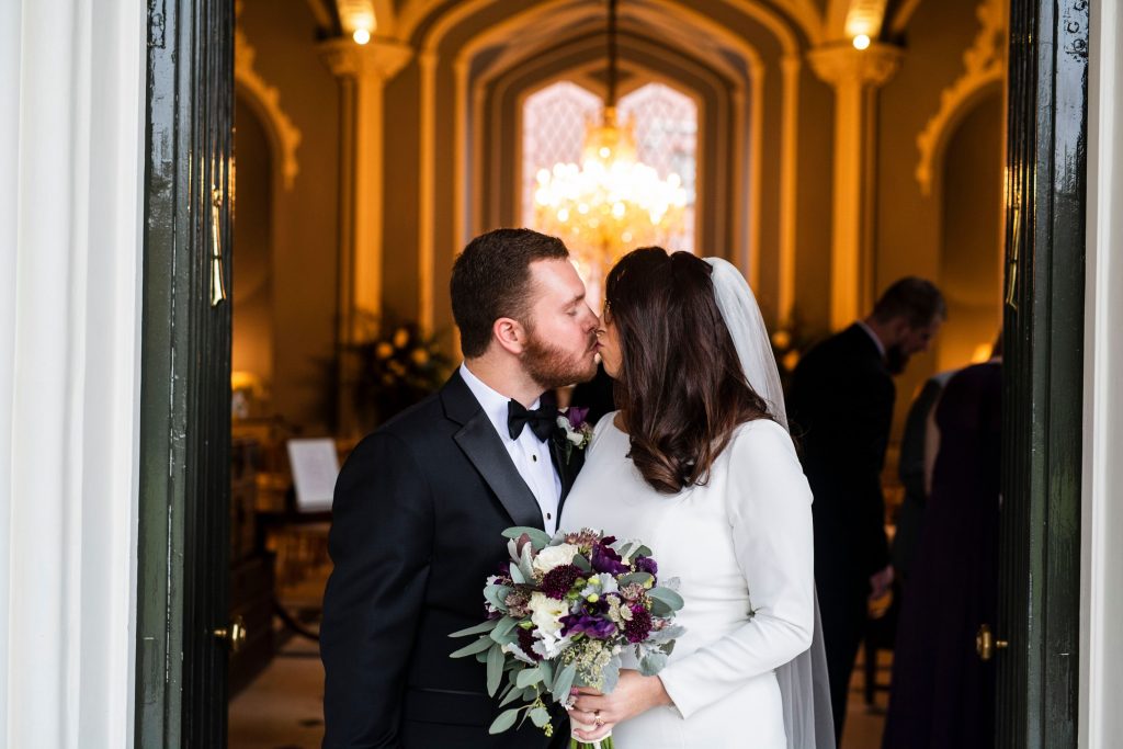 Couple kissing in front of church