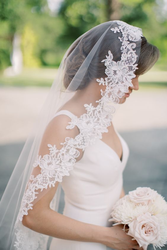 Bride wearing a mantilla veil.