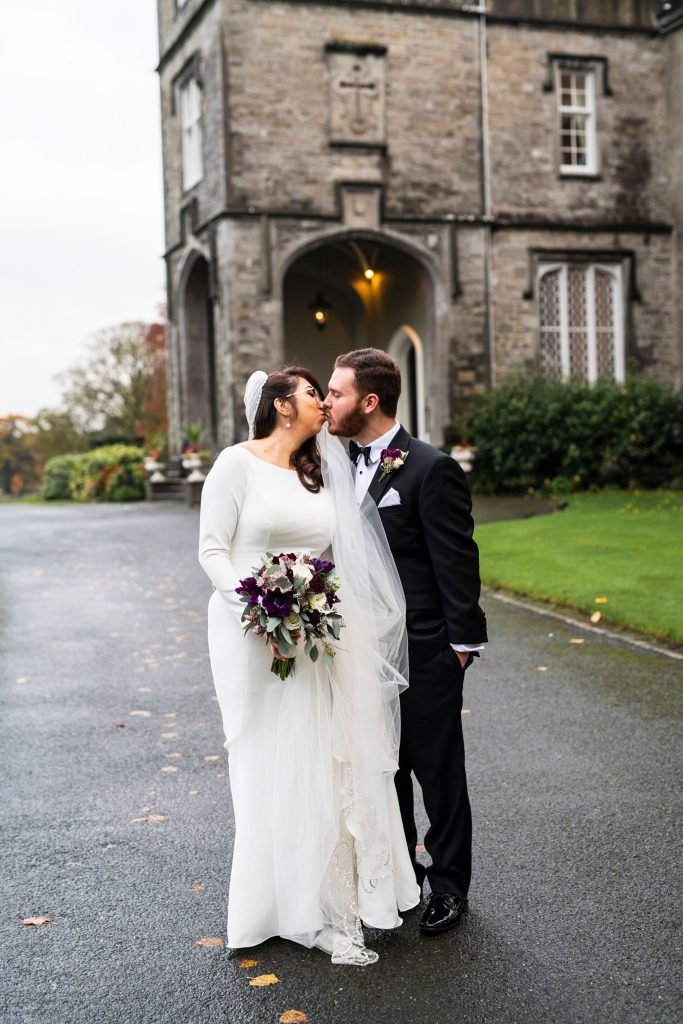 Couple kissing in front of castle