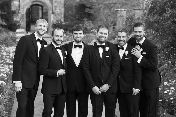 Groom and his groomsmen wearing tuxedos.