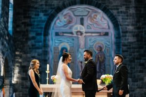 Couple on tha altar with witnesses