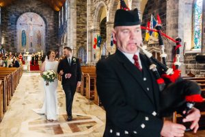 The Bagpiper leading the couple down the aisle