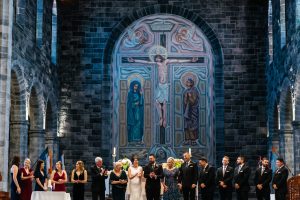 The Couple with their Wedding Party & Parents at the altar