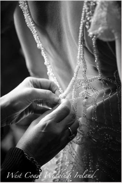 Michelle buttoning a bride's dress